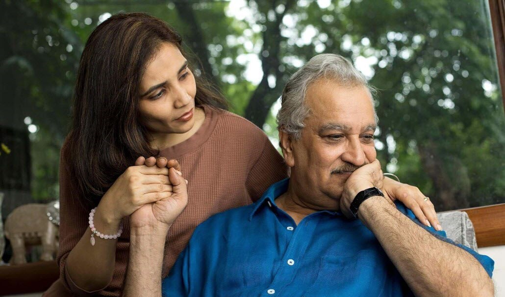 Caregiver comforts her aging father, coaxing him to open up to her.